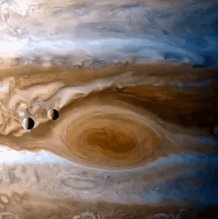 Cassini flew past Jupiter 25 years ago.Those 2 small moons shown are "lo" and "Europa" over Jupiter's Great Red Spot.
