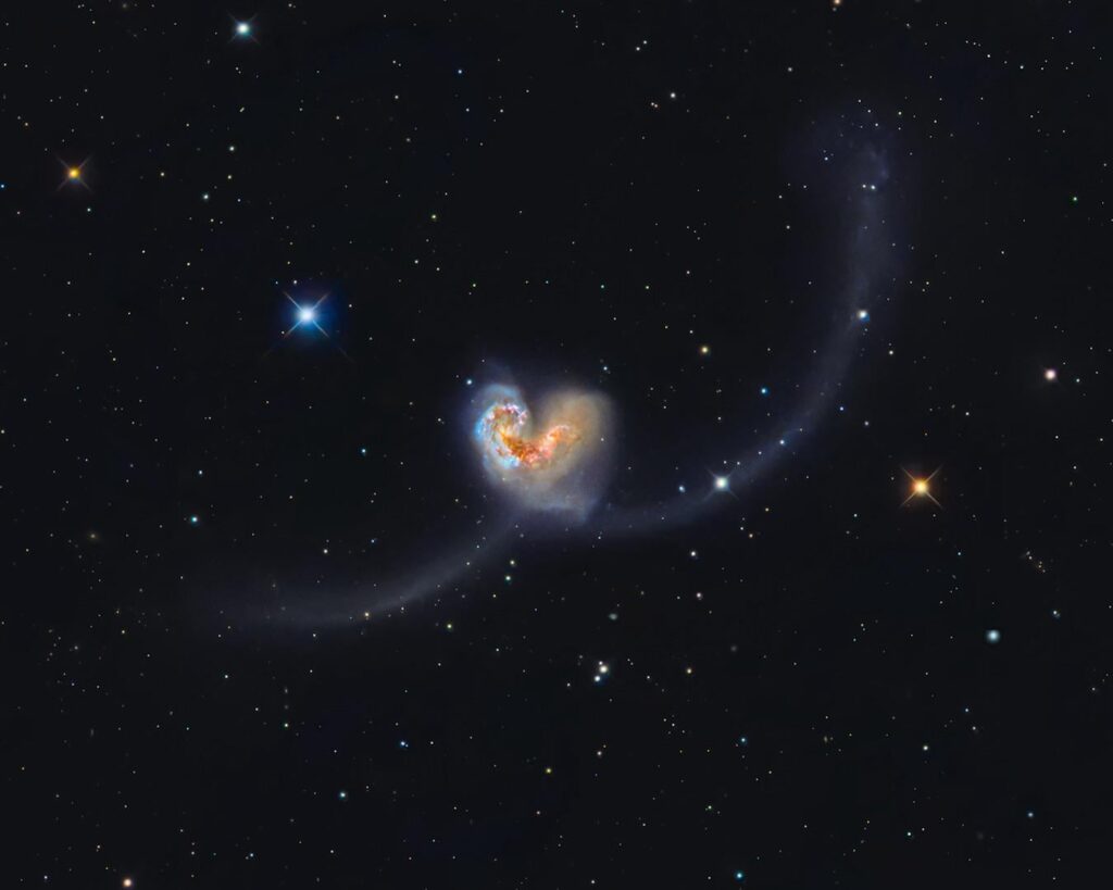 I photographed two galaxies that have been colliding for over 600 million years, and yet somehow - they formed a heart while doing it…