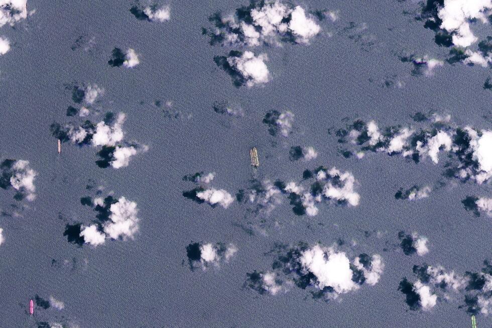 This handout satellite image released by Planet Labs PBC shows two vessels conducting what appears to be an offshore cargo transfer off the southeast coast of the Malay Peninsula near Singapore on March 24