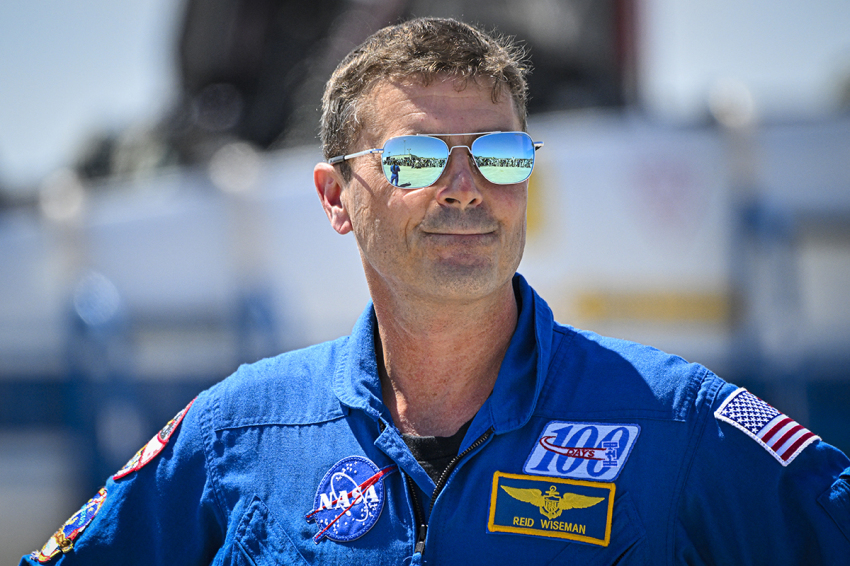 NASA astronaut and Artemis II Commander Reid Wiseman looks on during a welcome ceremony ahead of the Artemis II April 1 launch at Kennedy Space Center in Florida on March 27, 2026. NASA and Canadian Space Agency astronauts assigned to the Artemis II mission arrive at Kennedy Space Center in Florida on March 27, 2026, to begin final pre-launch preparations for the first crewed lunar flyby in the Artemis program. The journey, set to last around 10 days, will take the astronauts on a loop around the Moon, though they will not land on its surface. The crew comprises the first woman, the first person of color and the first non-American to take part in such a journey. 
