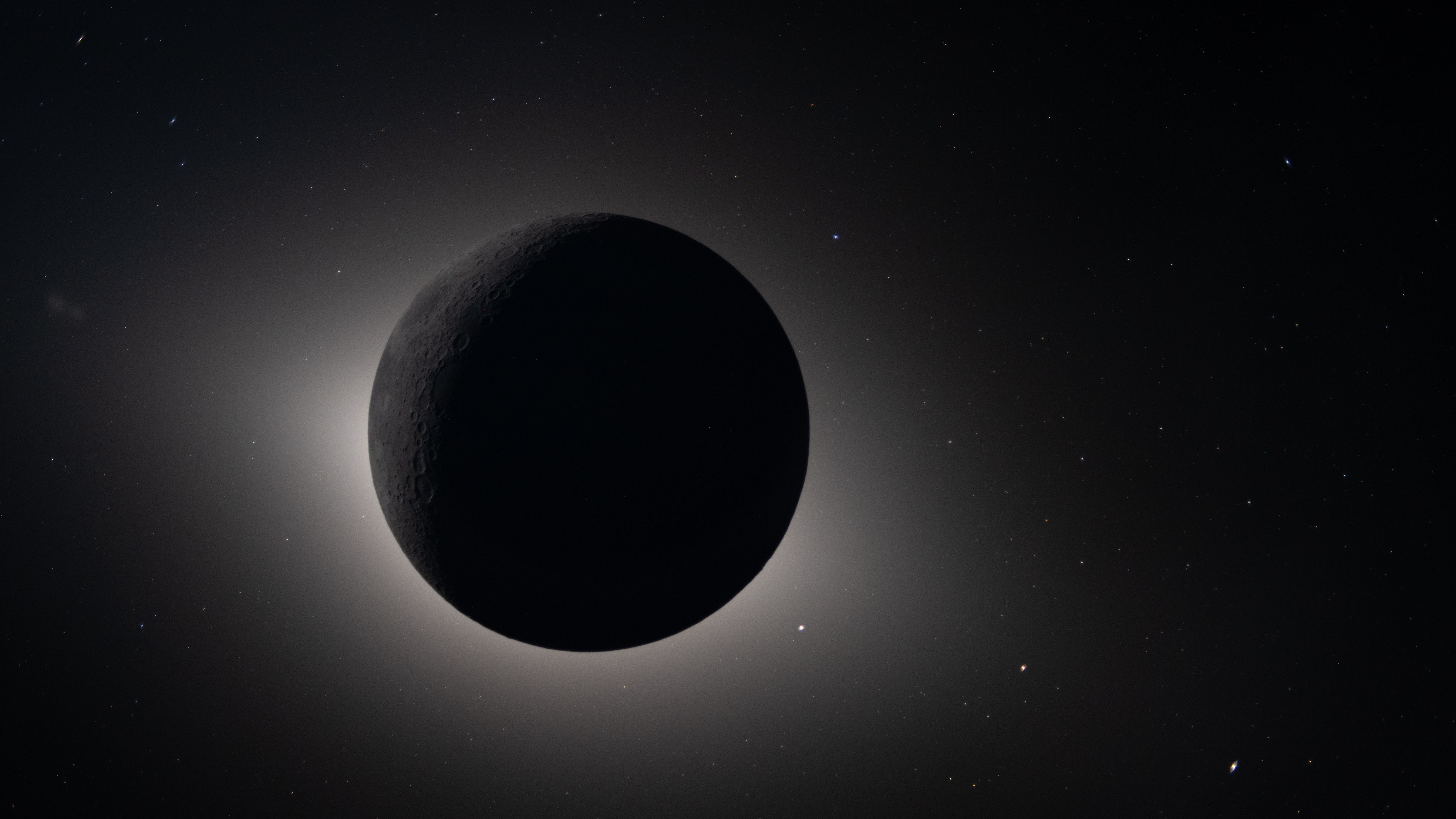 Captured by the Artemis II crew during their lunar flyby on April 6, 2026, this image shows the Moon fully eclipsing the Sun. 