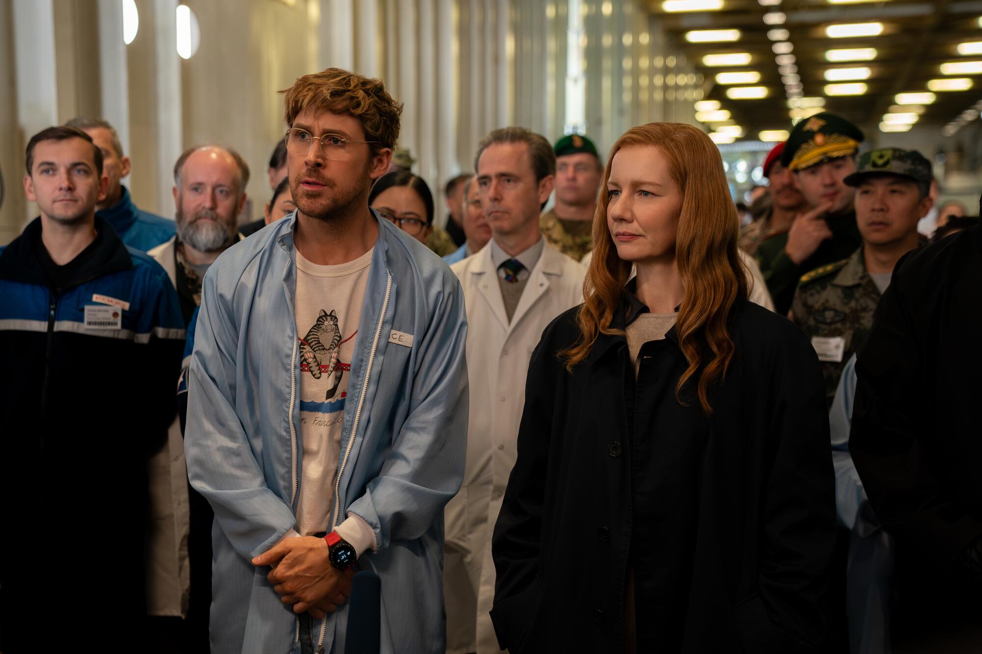 Ryan Gosling and Sandra Huller stand at the front of a crowd