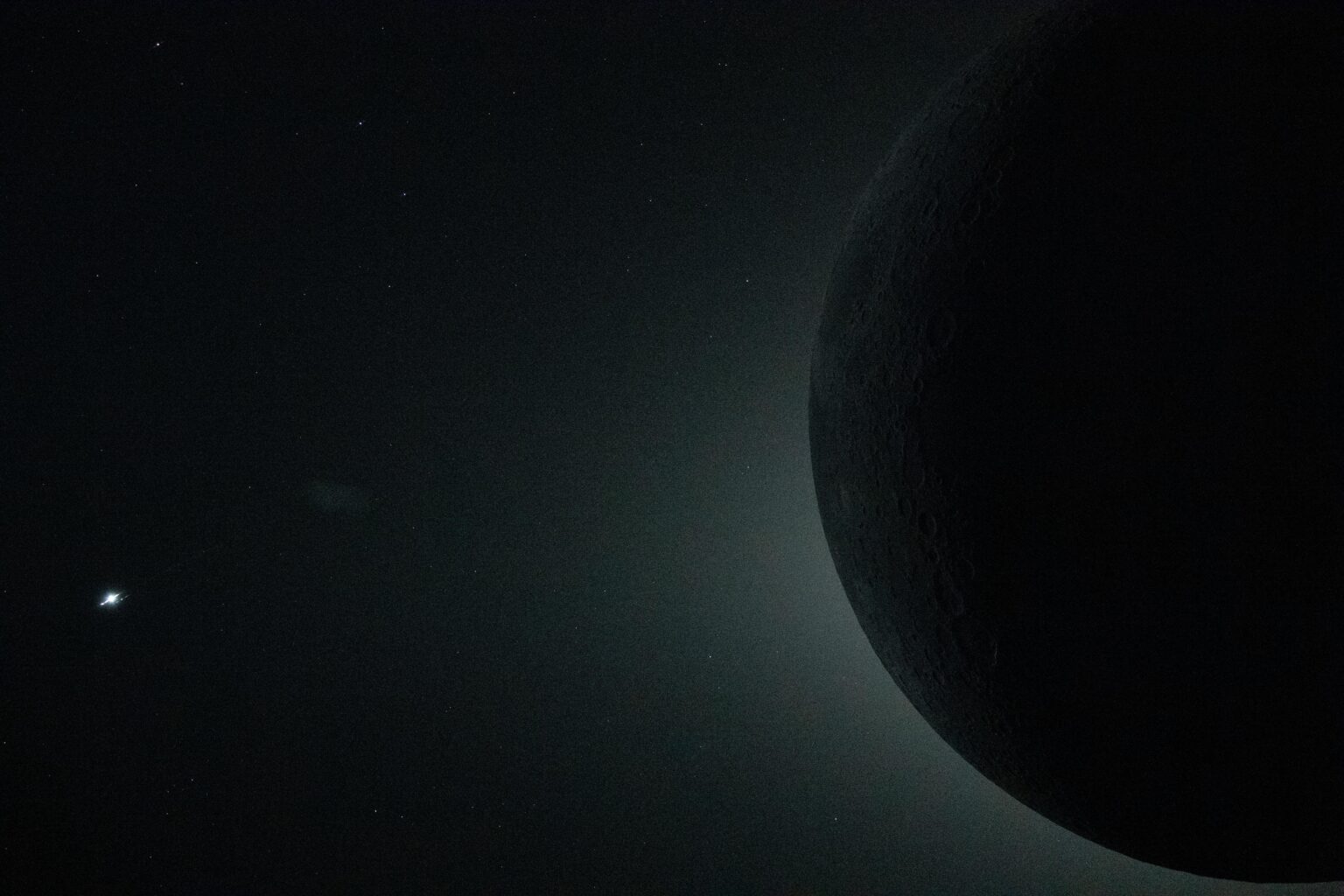 Artemis II Total Solar Eclipse, the bright silver glint on the left edge is the planet Venus.