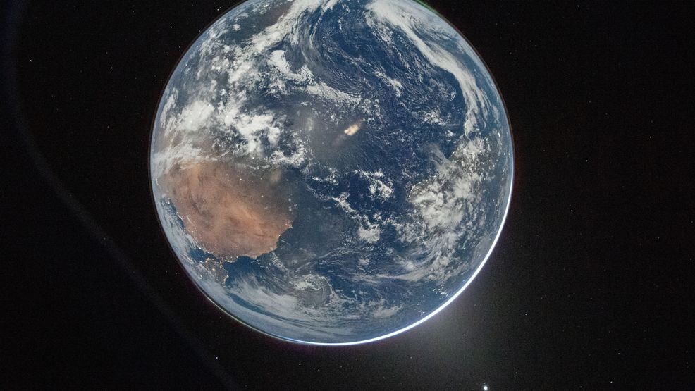 This image provided by NASA shows a view of Earth taken by NASA astronaut and Artemis II Commander Reid Wiseman from of the Orion spacecraft's window after completing the translunar injection burn on April 2, 2026. (NASA via AP)