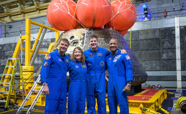 The Artemis II crew in front of the Orion space capsule