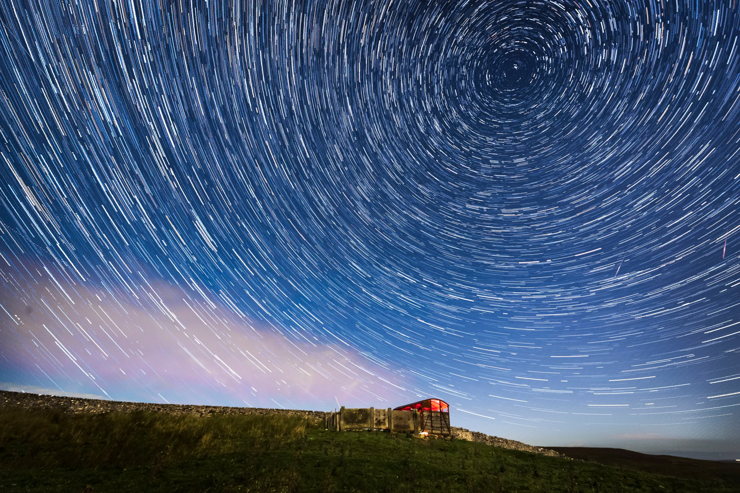 Digital composite of the Perseid meteor shower and star trails over the Yorkshire Dales National Park.