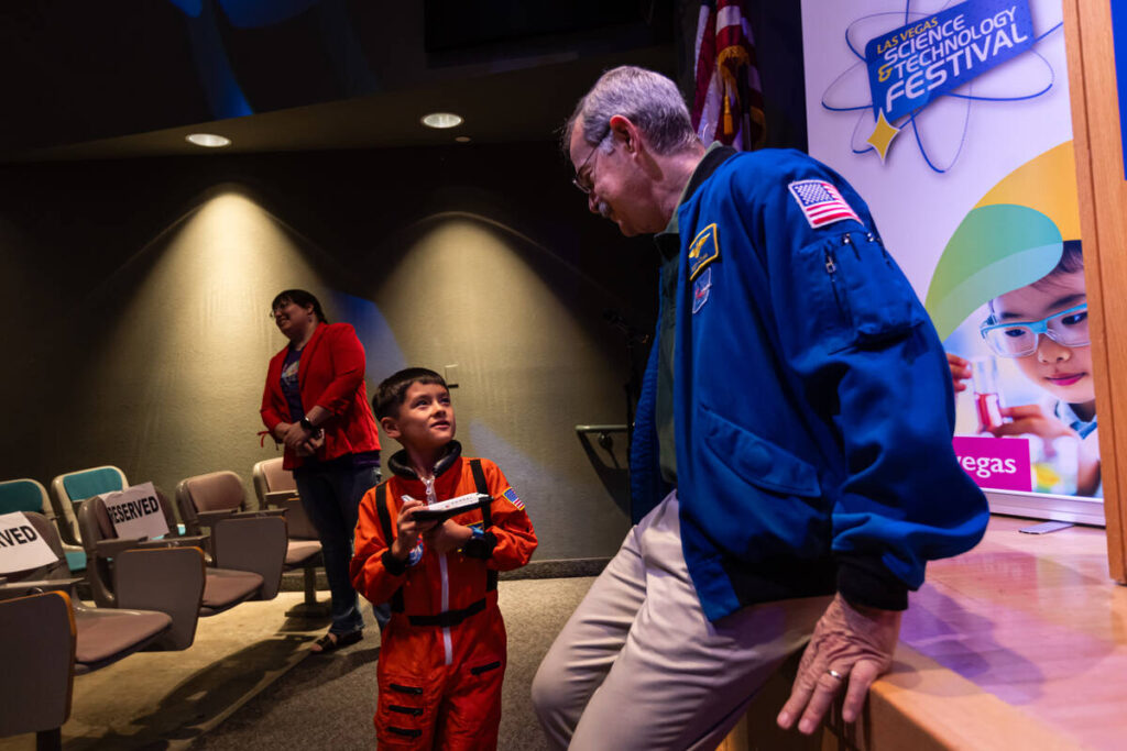 Scott Altman, former NASA astronaut and retired U.S.Navy Captain, right, greets Elias Bacal, 7, ...