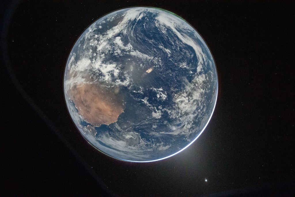 Earth from the Orion spacecraft's window, showing West Africa and the Atlantic Ocean.