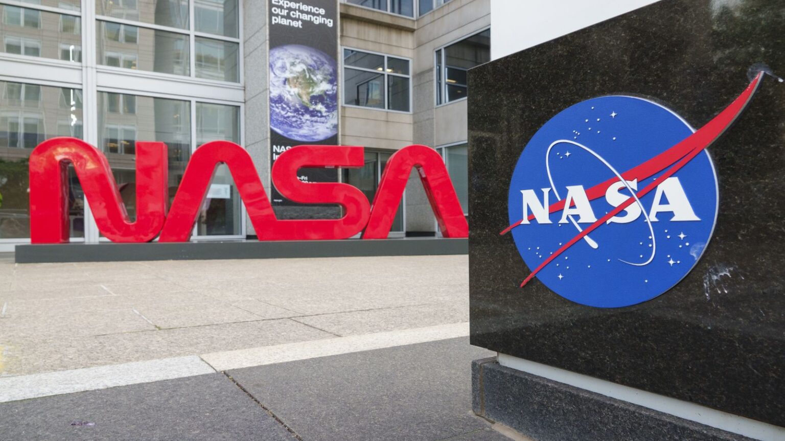 NASA science faces ‘very serious threat’ from new White House budget, experts say Large red letters spelling out NASA as a logo with a blue NASA icon nearby at the agency's headquarters.