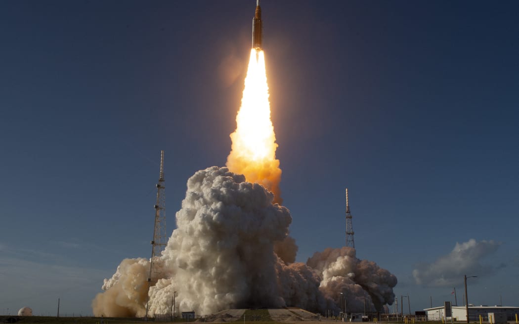 The Artemis II crewed lunar mission lifts off from Pad 39B at Kennedy Space Center in Cape Canaveral, Florida, on April 1, 2026. Four astronauts blasted off aboard a massive NASA rocket April 1 on a long-anticipated journey around the Moon, the first crewed lunar flyby in more than 50 years. With an intense roar that reverberated far beyond the launchpad, the enormous orange-and-white rocket carried three Americans and one Canadian away from Florida's Kennedy Space Center at approximately 6:35 pm local time, according to an AFP journalist onsite. "We're going to the Moon!" yelled a spectator. (Photo by Jim WATSON / AFP)