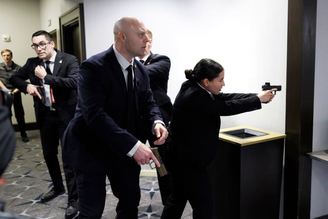 Armed secret service agents in a corridor