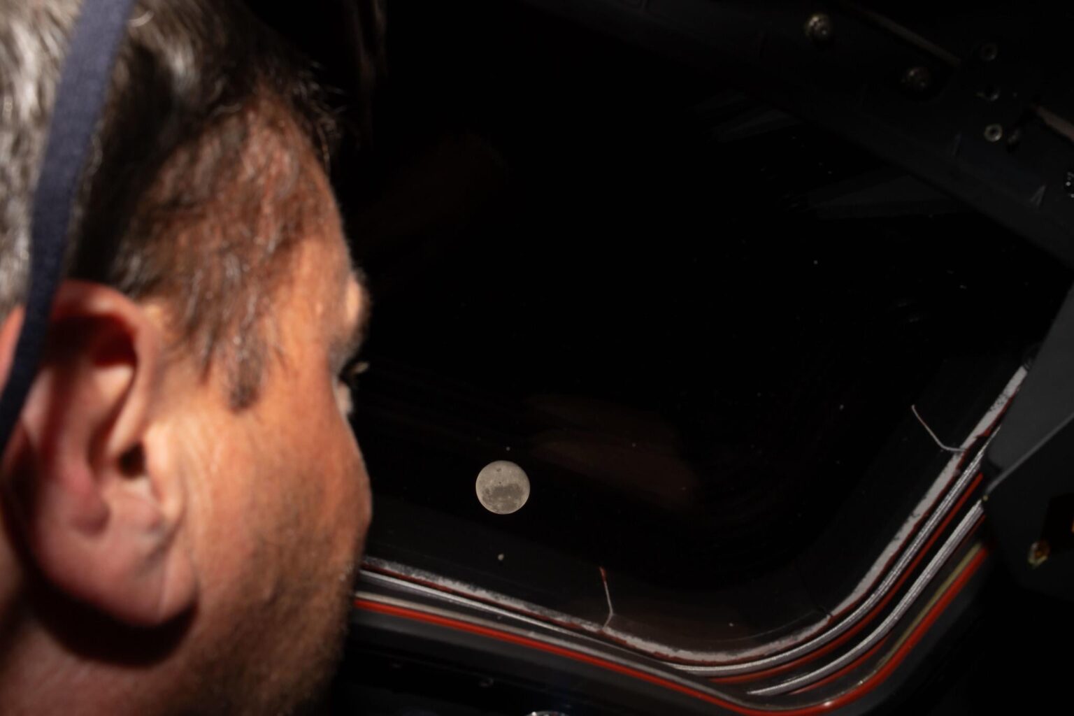 Lunar Looking. Artemis II commander and NASA astronaut Reid Wiseman looks out one of the Orion spacecraft's main cabin windows at the Moon ahead of the crew's lunar flyby on April 6, 2026.