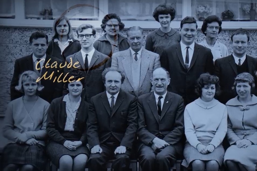 A black and white group shot of teachers seated in three rows.