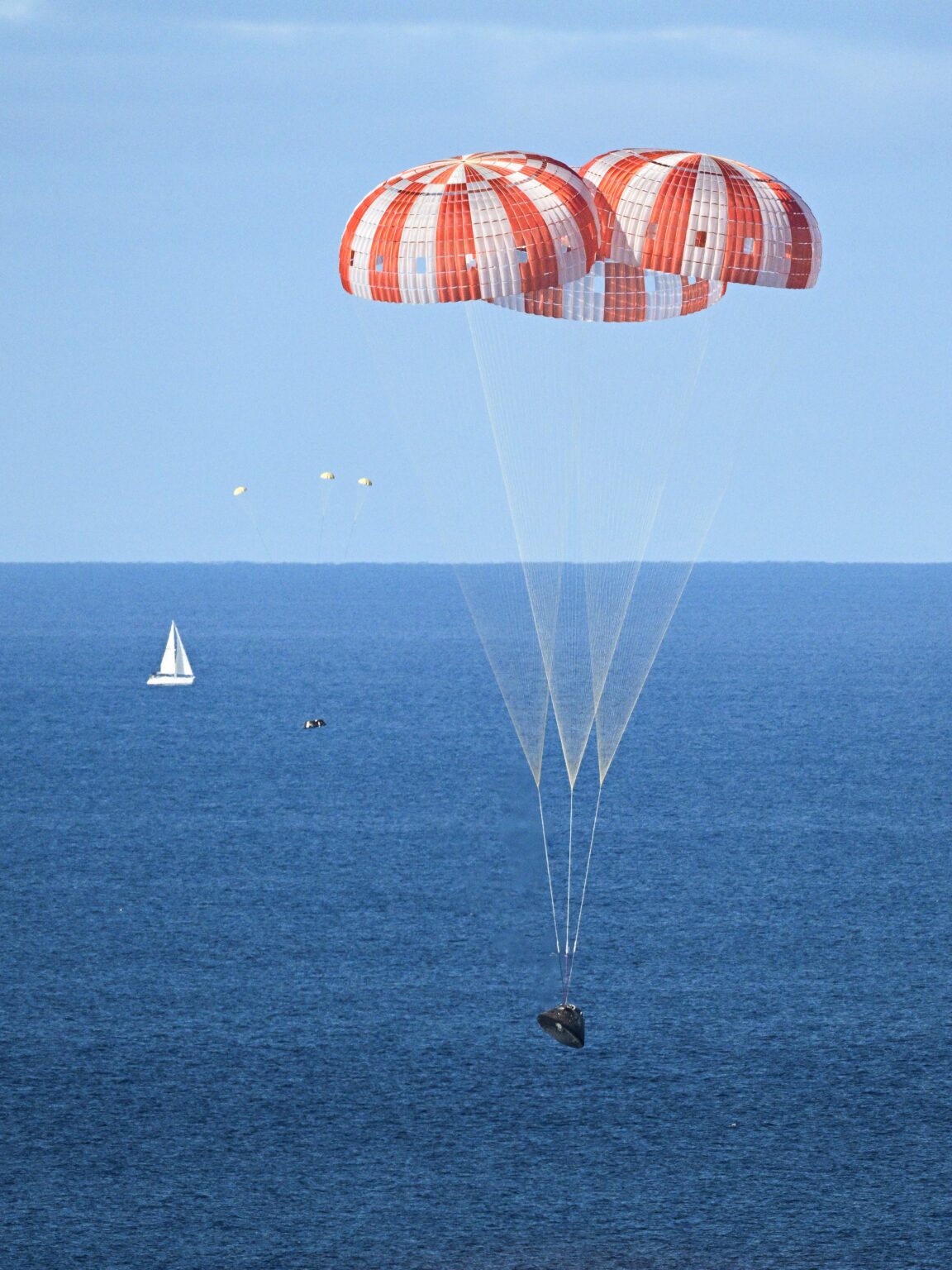 Sailboat near NASA's Orion spacecraft carrying Artemis II crew about Splashdown on April 10, 2026