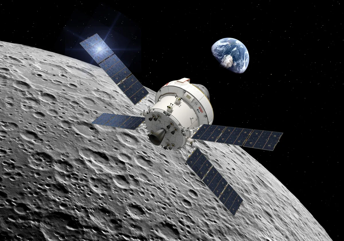 The Orion capsule in space with the Moon and Earth in the background