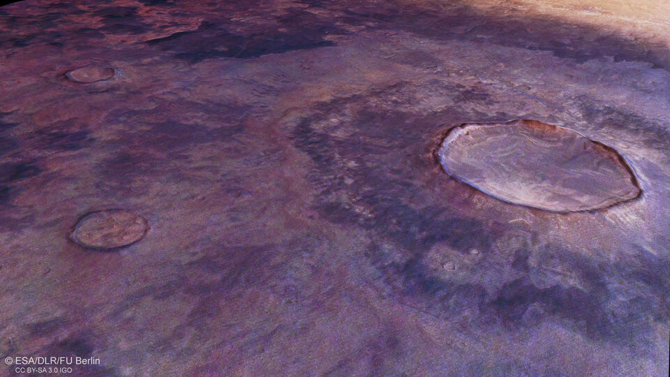 Bird's-eye view of an impact crater on the ash-y side of the main image