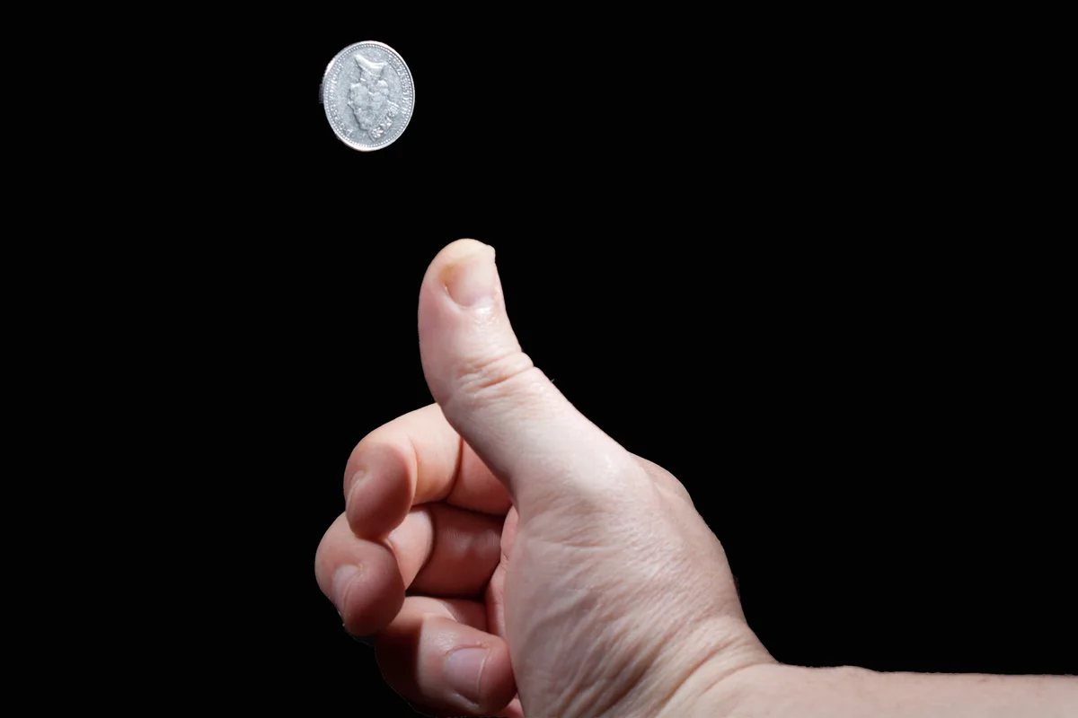 Hand flipping a coin