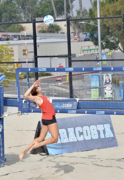 Reese Maffitt (#13) jumps to spike the volleyball on their opposing duo from San Diego City. Maffitt and her duo partner Emma Bambe (#12) this match against San Diego City on March 27 at MiraCosta college.