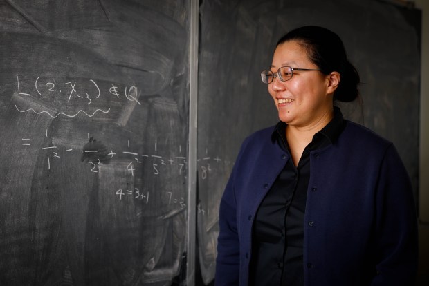 Yunqing Tang, the winner of the 2026 New Horizons in Mathematics Award, stands next to a chalk board with her award winning work at UC Berkeley in Berkeley, Calif., on Friday, April 10, 2026. (Shae Hammond/Bay Area News Group)