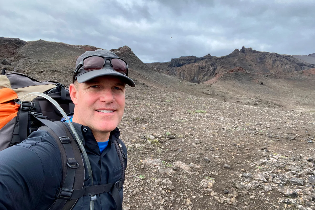 Jeremy Hansen standing on a volcanic landscape.