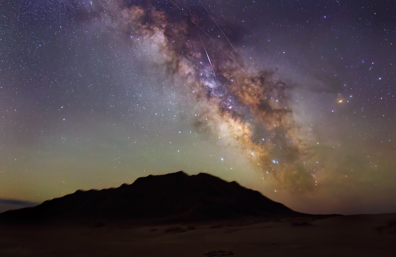 Starry sky with Milky Way, a Lyrid meteor and some satellite trails.