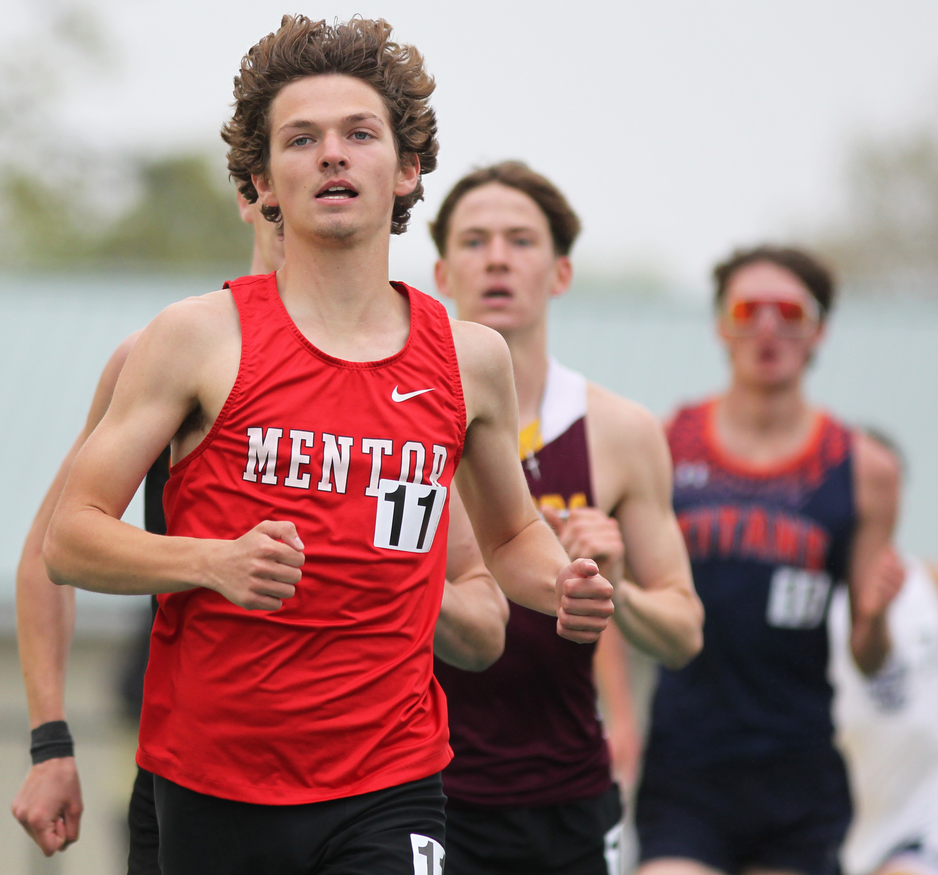 Runners compete in the 1600 meter run at the Comet...
