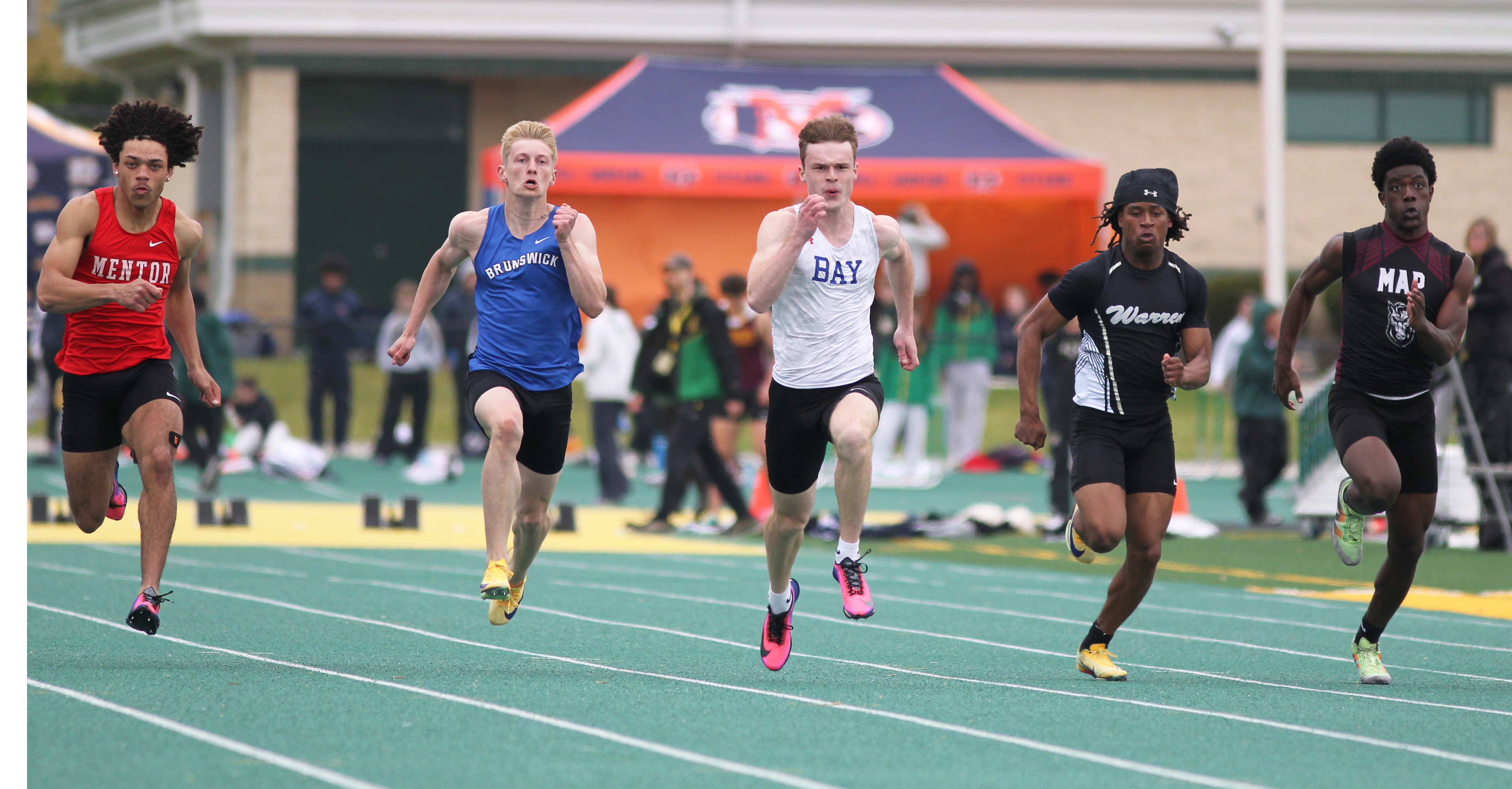 Runners compete in the men's 100 meter dash at the...