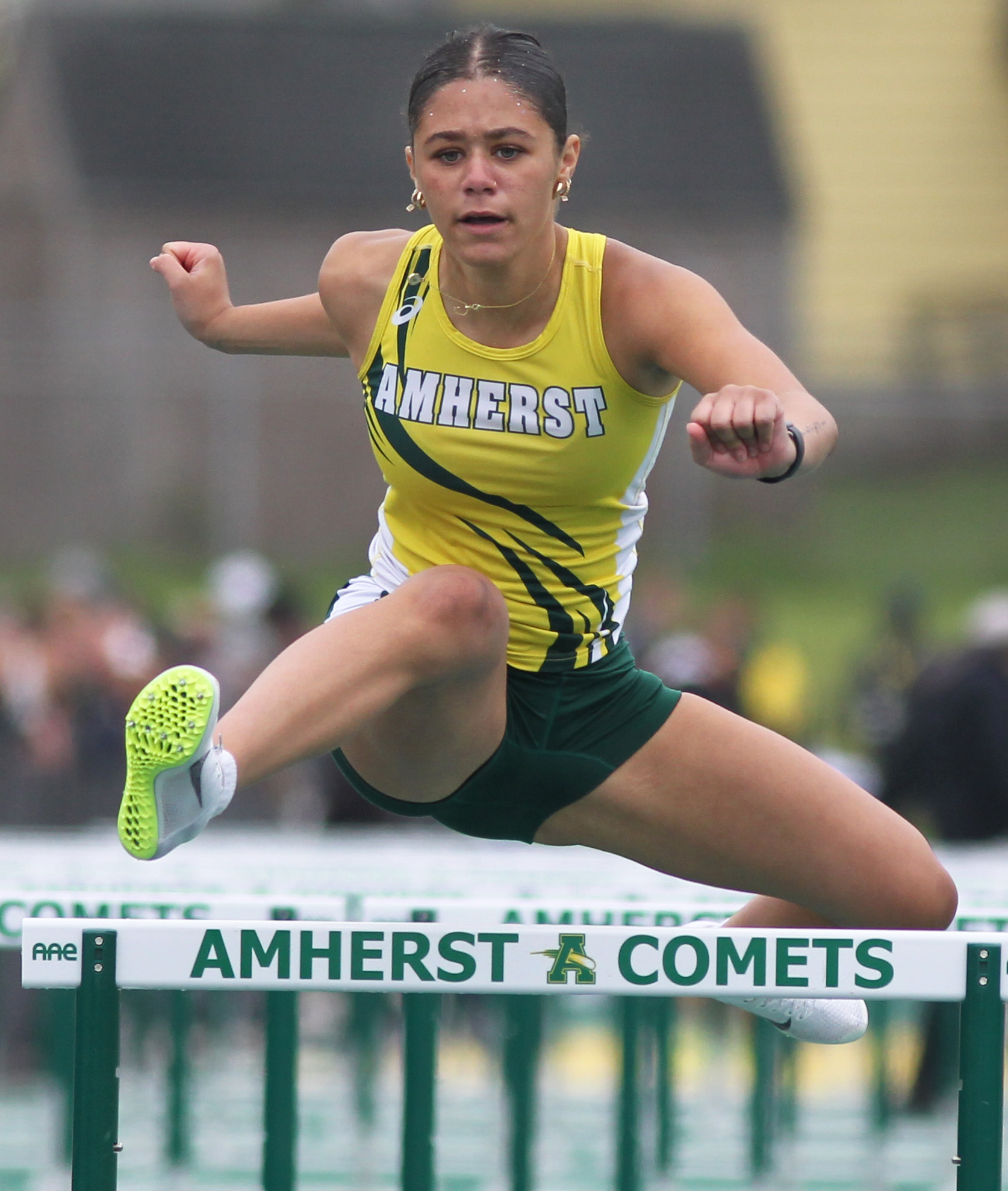 An Amherst athlete competes in the 100 meter hurdles at...