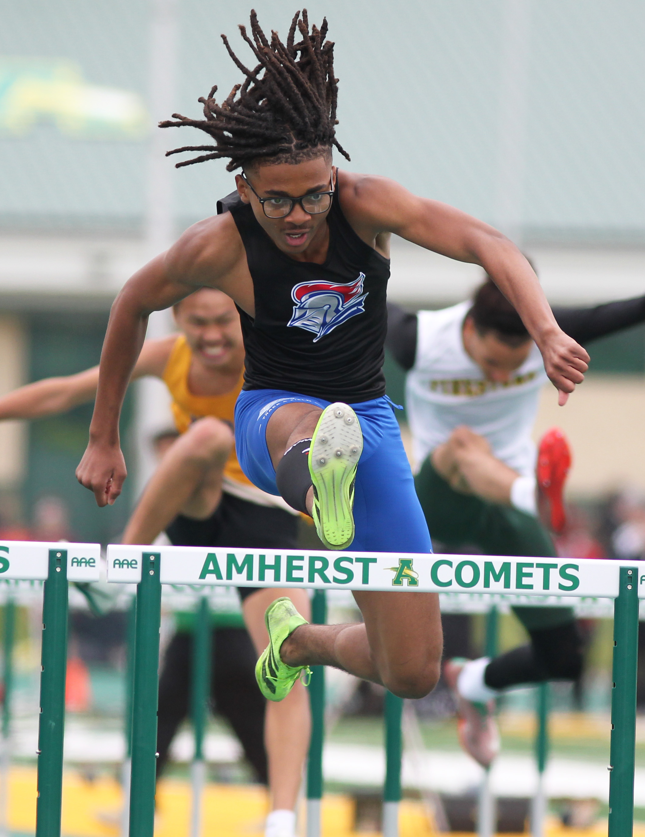 Runners compete in the 110 meter hurdles at the Comet...