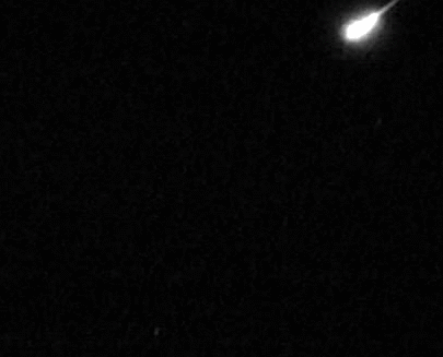 Animation of blazing meteor expanding to fireball as it flies from right to left.