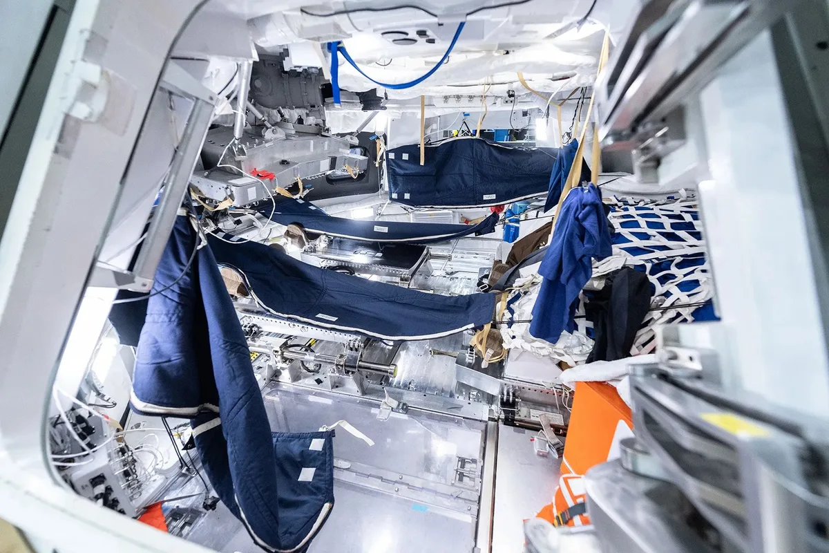 Interior of the Orion capsule with hammocks hung up in the space
