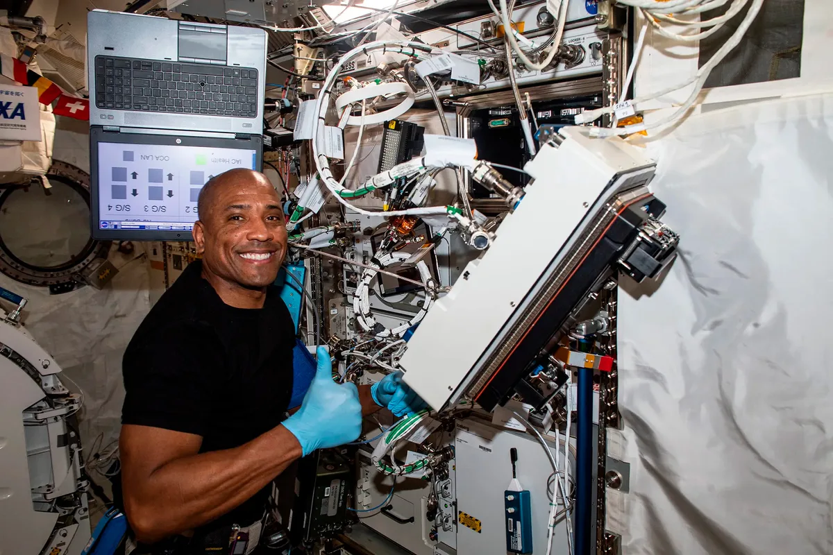 Victor Glover in the ISS working with equipment