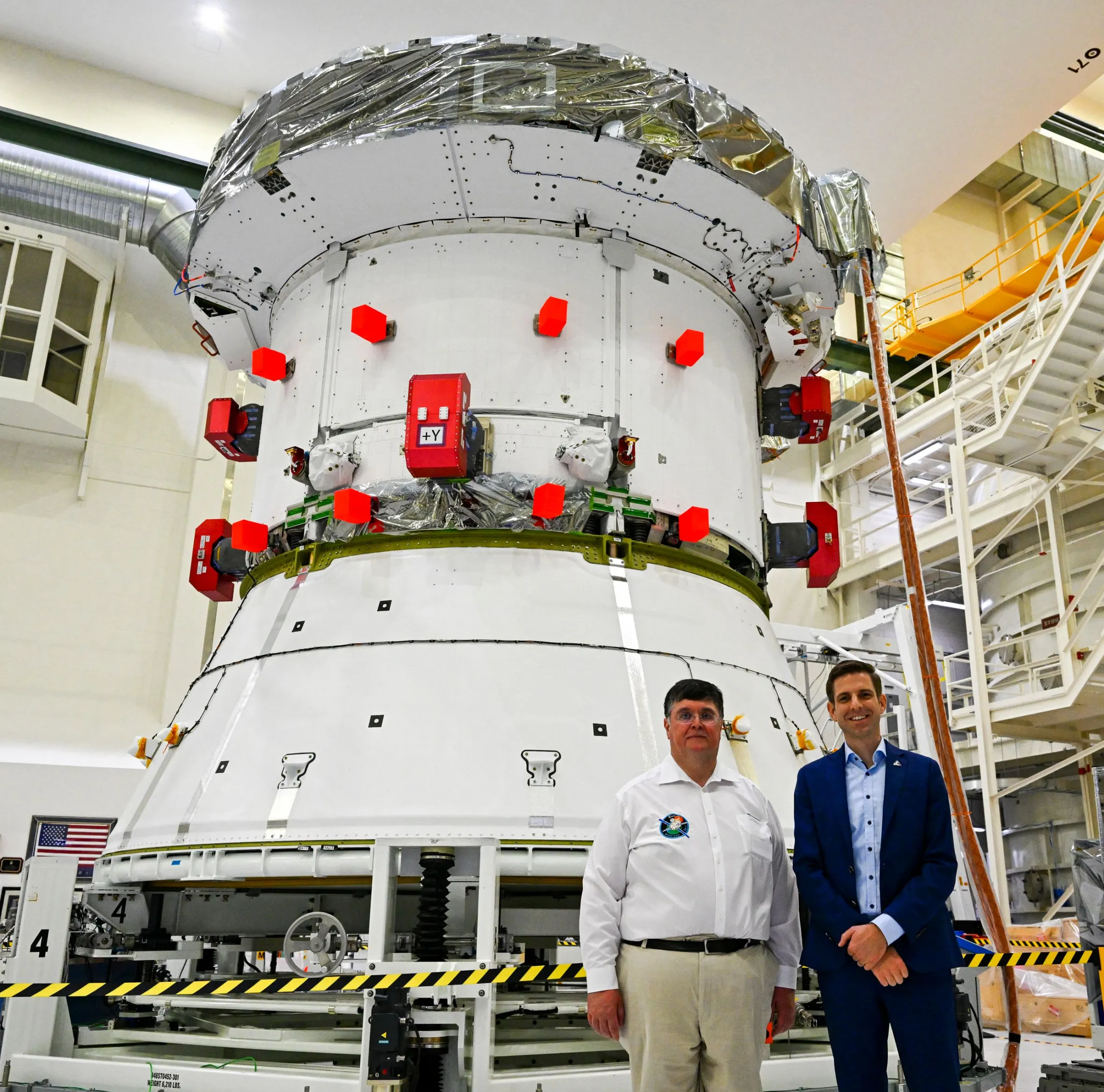 Philippe Berthe and Kai O Bergemann pose with the Artemis II European Service Module.