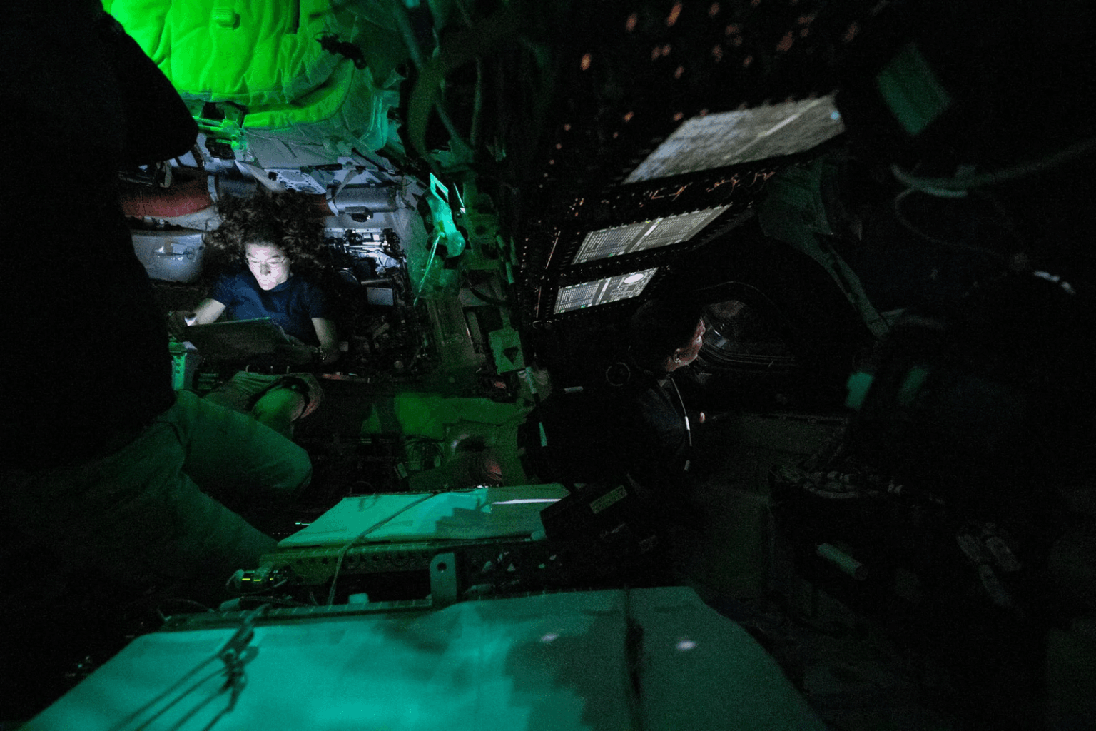 NASA astronaut Koch is illuminated by a screen inside the darkened Orion spacecraft on the third day of the Artemis II mission on April 3. (NASA/Handout via Reuters)