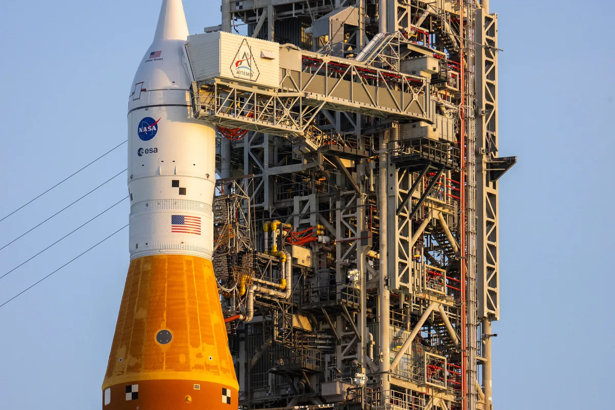 NASA's Artemis II Space Launch System rocket and Orion spacecraft rest on a launch pad at Kennedy Space Center.