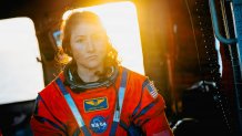 NASA astronaut Christina Koch sits in an U.S. Navy MH-60S Seahawk attached to Helicopter Sea Combat Squadron (HSC) 23 on the flight deck of the San Antonio Class amphibious transport dock USS John P. Murtha (LPD 26) after returning from space on Apr. 10, 2026. John P. Murtha is underway in the U.S. 3rd Fleet area of operations supporting NASA’s Artemis II mission, retrieving the crew and spacecraft following their return to Earth and splashdown in the Pacific Ocean. NASA’s Artemis II mission sent four a