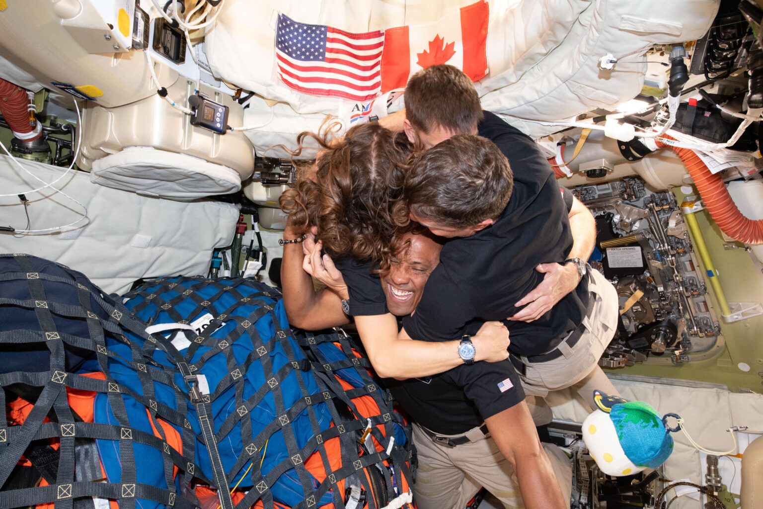 Astronauts group hug during Artemis II mission