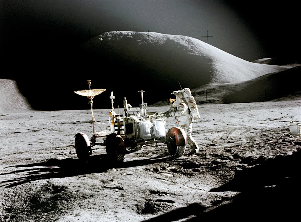 A photo of astronaut James B. Irwin working at the Lunar Roving Vehicle while on the moon during Apollo 15. 