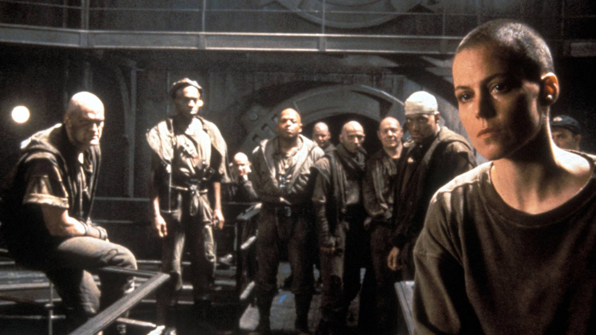 Sigourney Weaver as Ellen Ripley with the supporting cast in the background in "Alien 3"