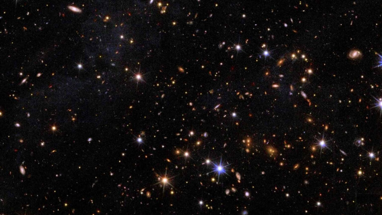 A deep-space composite image from the Hubble and Euclid telescopes showing the Perseus galaxy cluster, with a circle highlighting the faint star clusters of CDG-2.