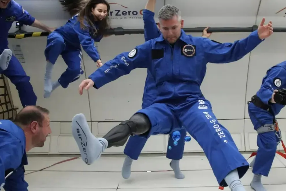 John McFall and other astronauts floating in a Zero-G plane.