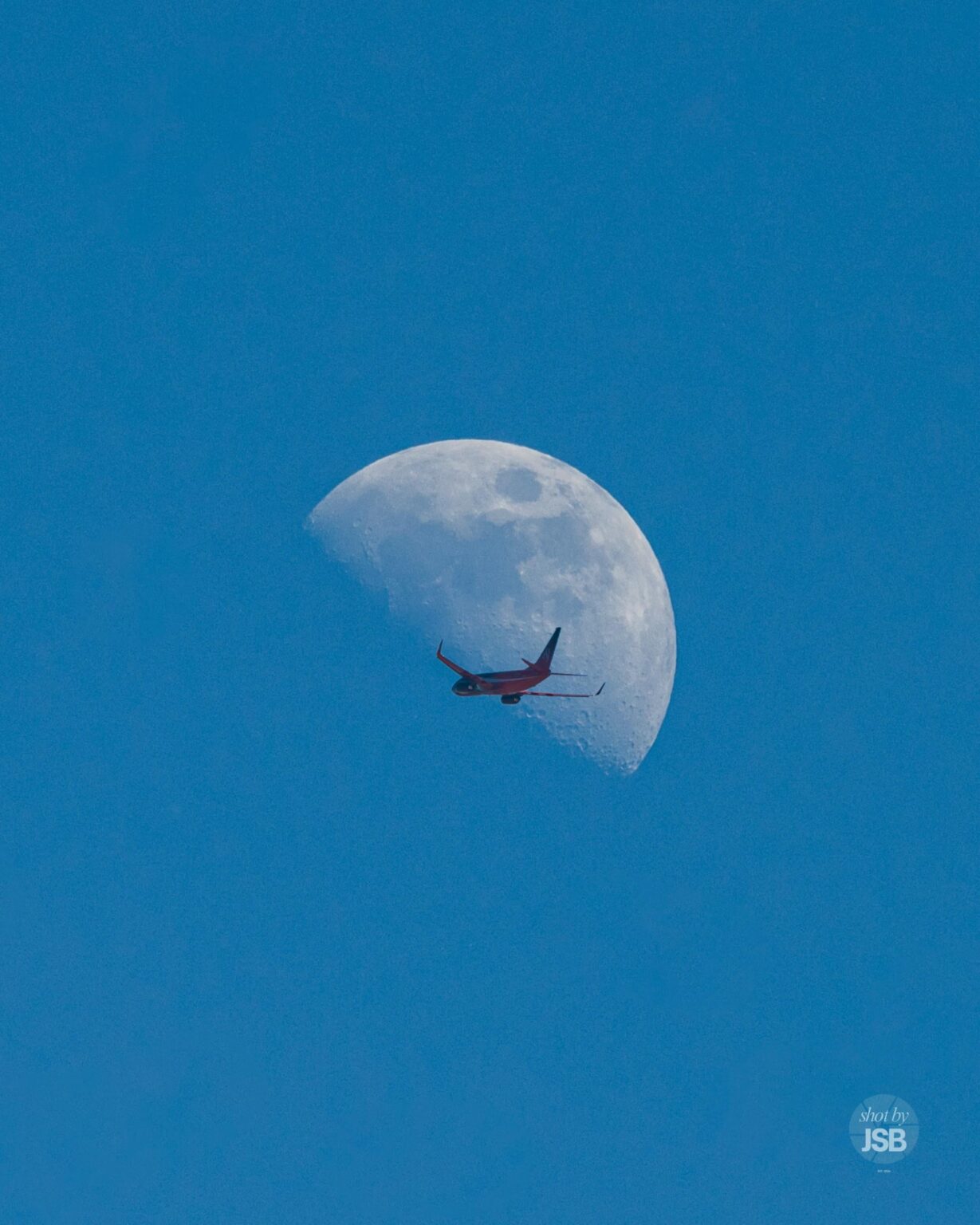 Shot a plane crossing the moon during the afternoon