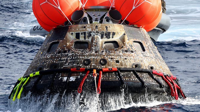NASA's Orion Capsule is drawn to the well deck of the USS Portland following a successful uncrewed Artemis I Moon Mission after it splashed down in the Pacific Ocean off the coast of Baja California, Mexico, on December 11, 2022. Orion was launched November 16 on the Artemis rocket for a 25-day mission to the Moon. The main goal of this mission was to test Orion's heat shield -- for the day when it is humans and not test mannequins riding inside.