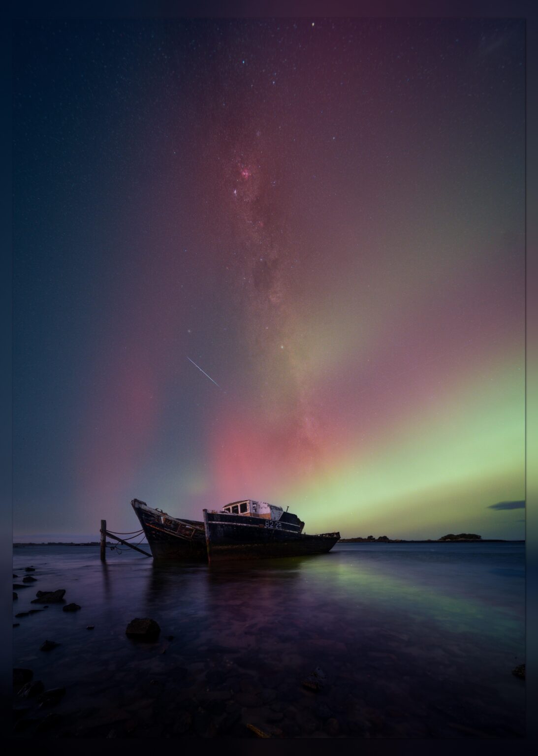 Aurora Australis over two moored ships