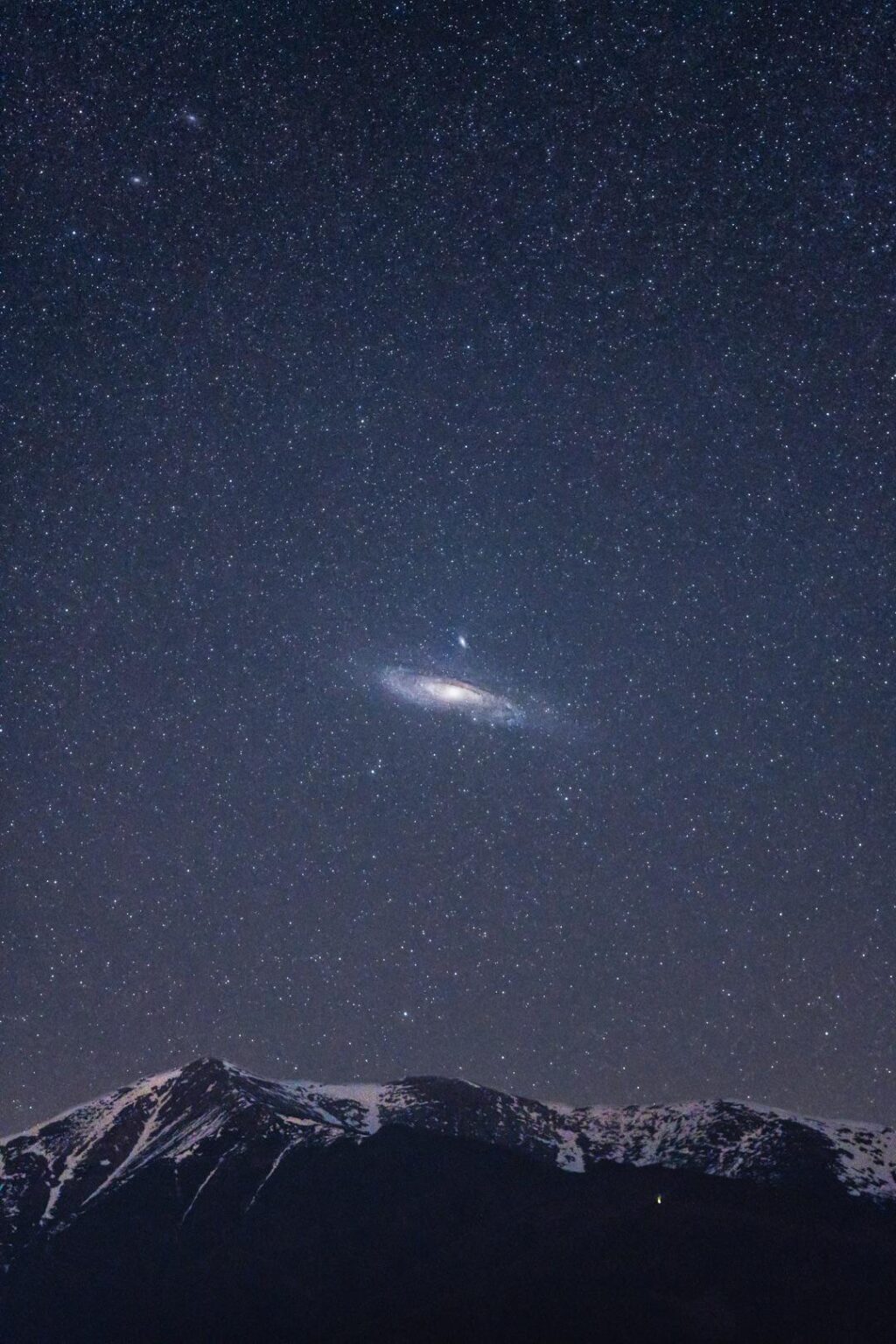Andromeda galaxy over mountains
