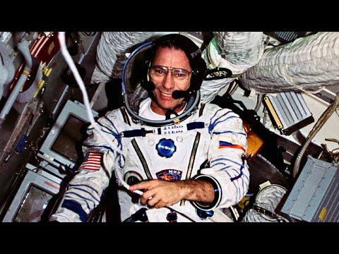 NASA Astronaut Colonel John Blaha transmits to mission control while observing an alien spacecraft