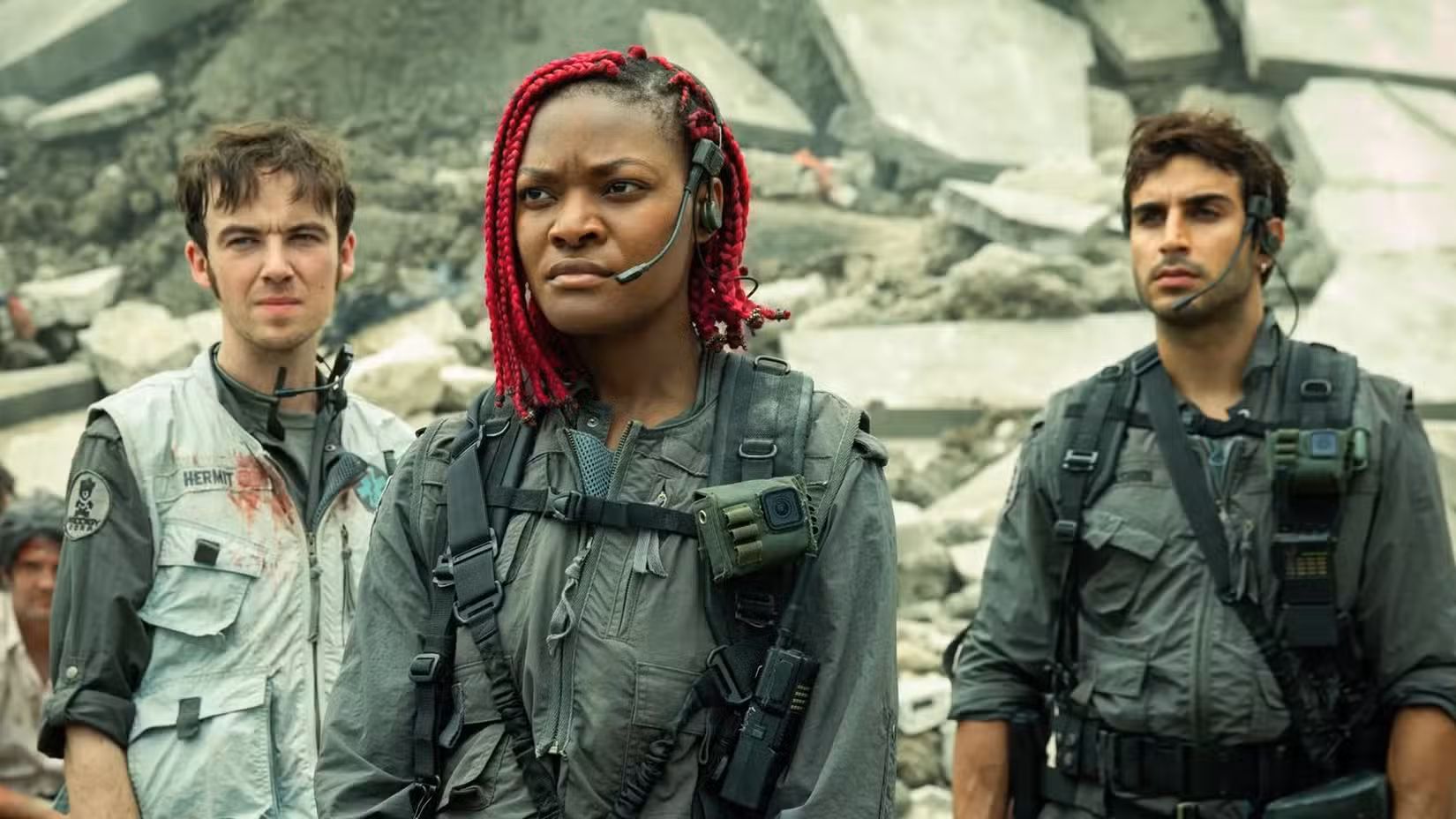 Three characters standing by rubble in Alien Earth