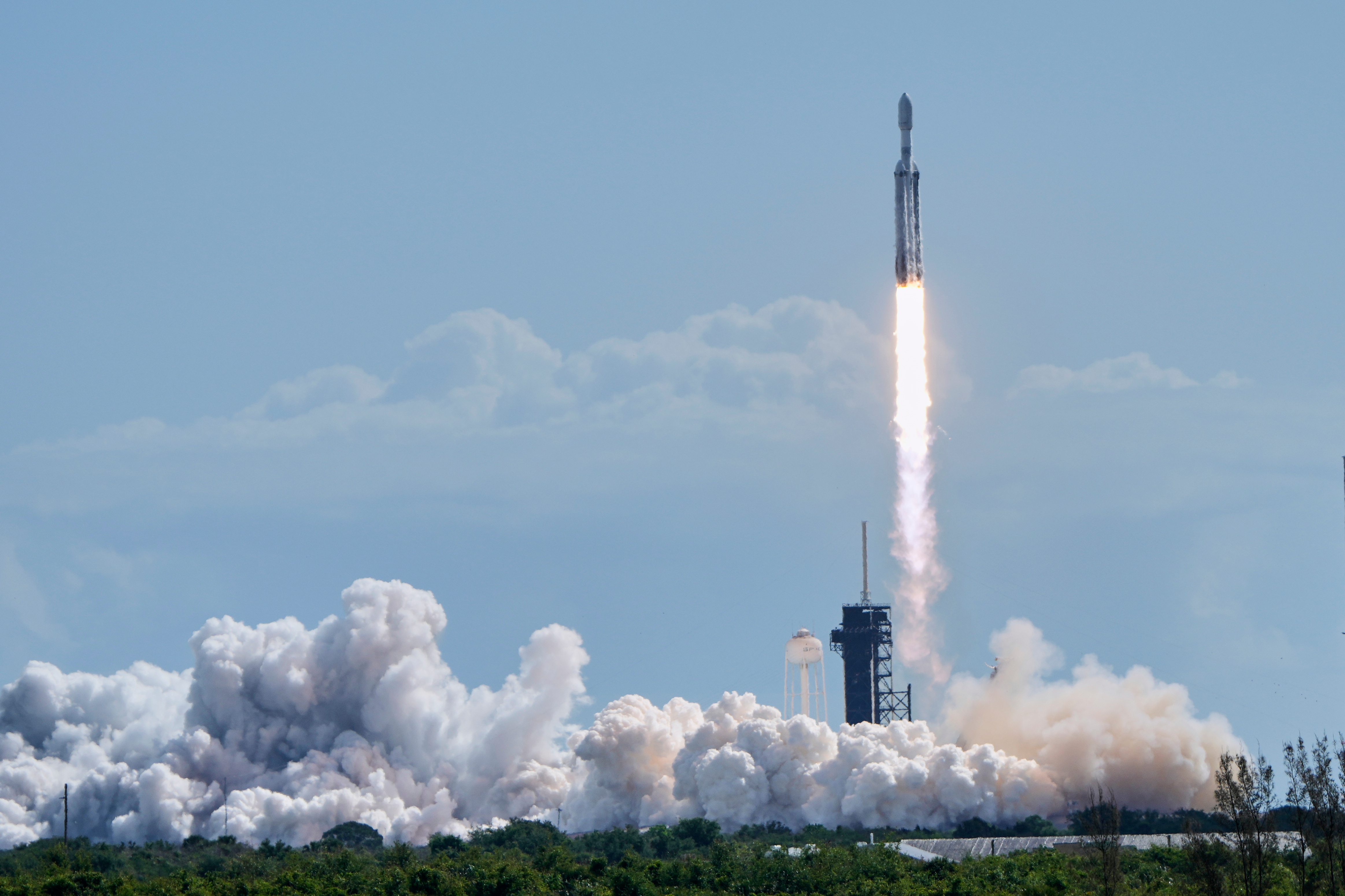 A SpaceX Falcon Heavy rocket lifts off from pad 39A...