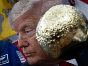 A model of the moon sits in front of US President Donald Trump while he meets with Artemis II Astronauts in the Oval Office of the White House in Washington, DC, on April 29, 2026.