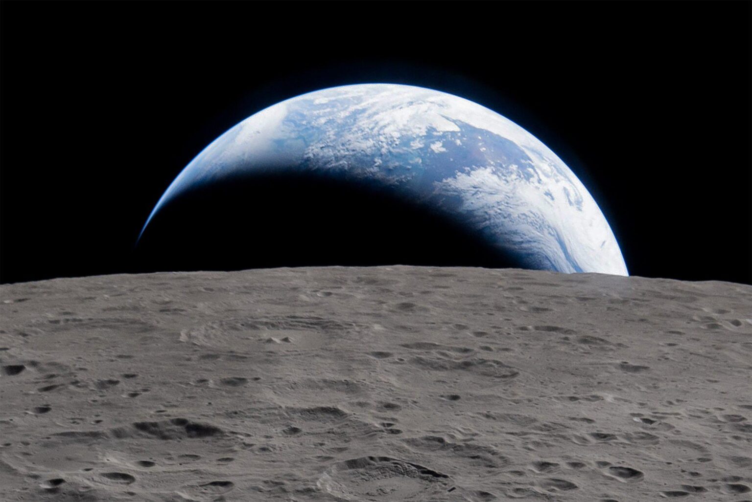 Earth setting beyond the limb of the Moon—a view captured on camera by the ArtemisII crew on April 6, 2026 from a point farther than any humans had ever ventured before. (Crop of original image). Processed by Jason Major